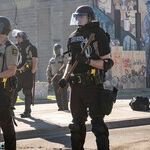 Assaulted and Vilified, the Cops Save the Cities